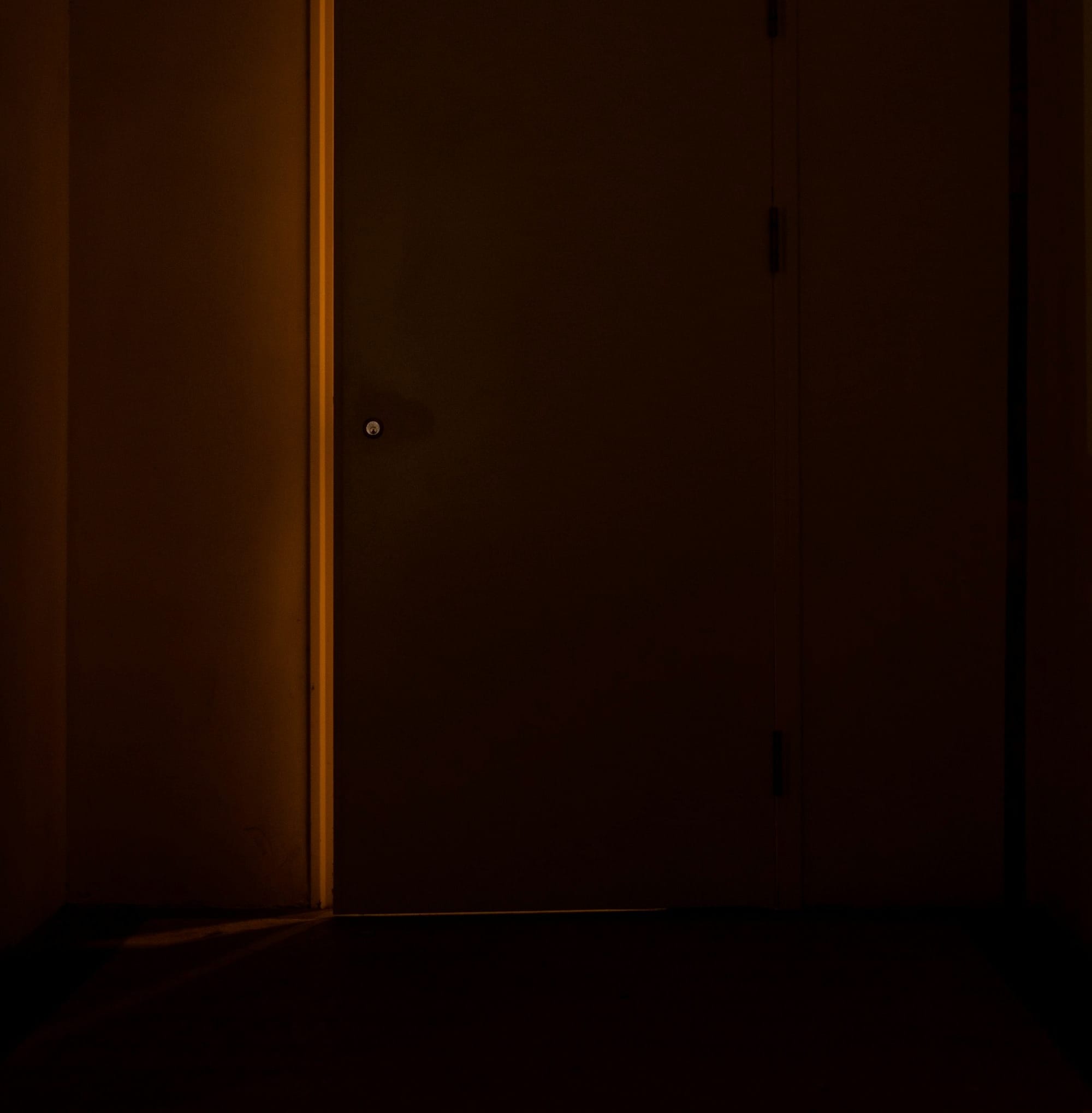 a door in a dark room with a light on